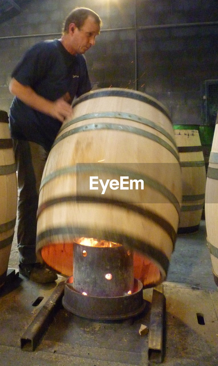 Cooper making barrels at workshop