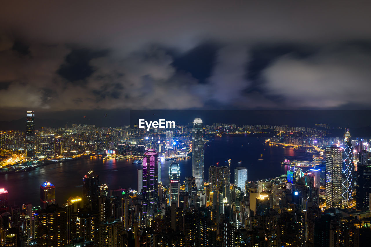 Illuminated cityscape against sky at night