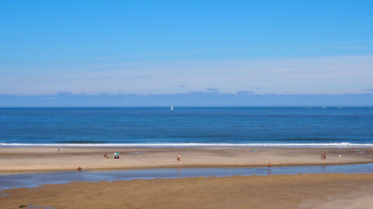 Scenic view of beach against blue sky