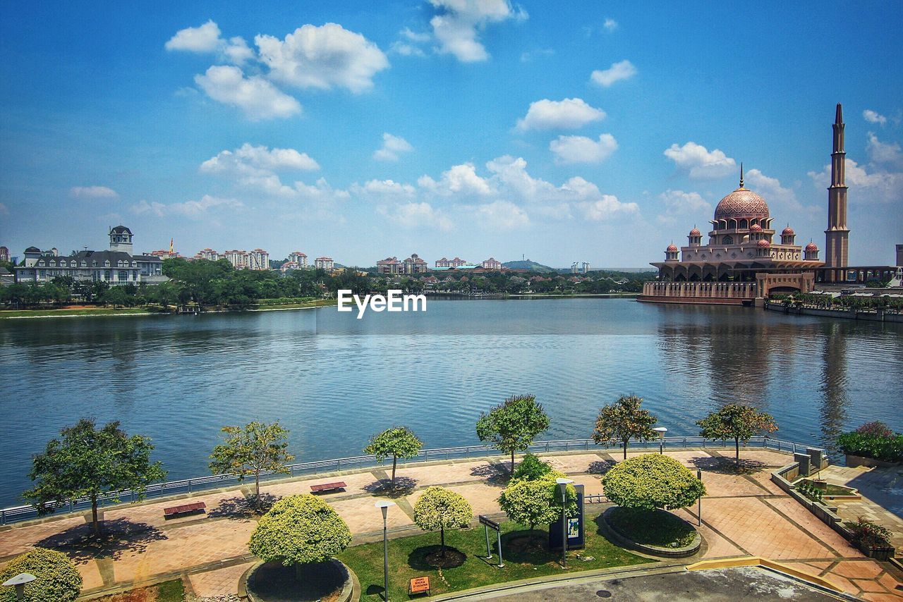 Putra mosque by lake against blue sky