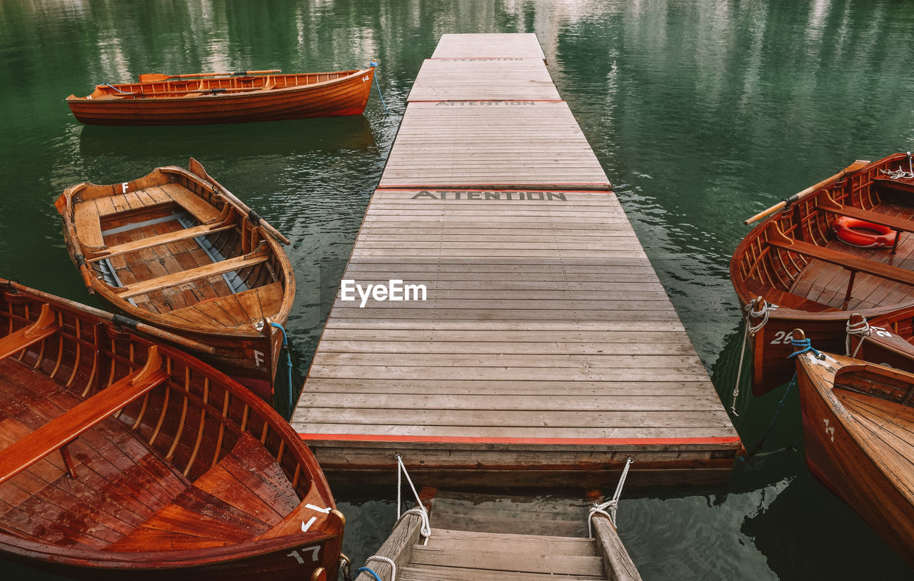 Boats moored at pier in lake