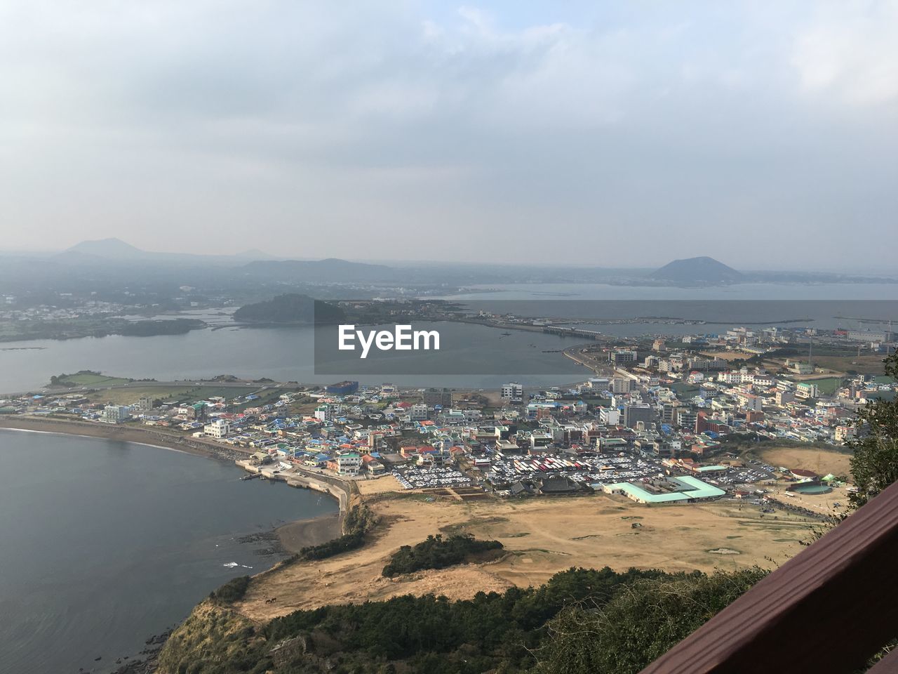 High angle view of townscape by sea against sky