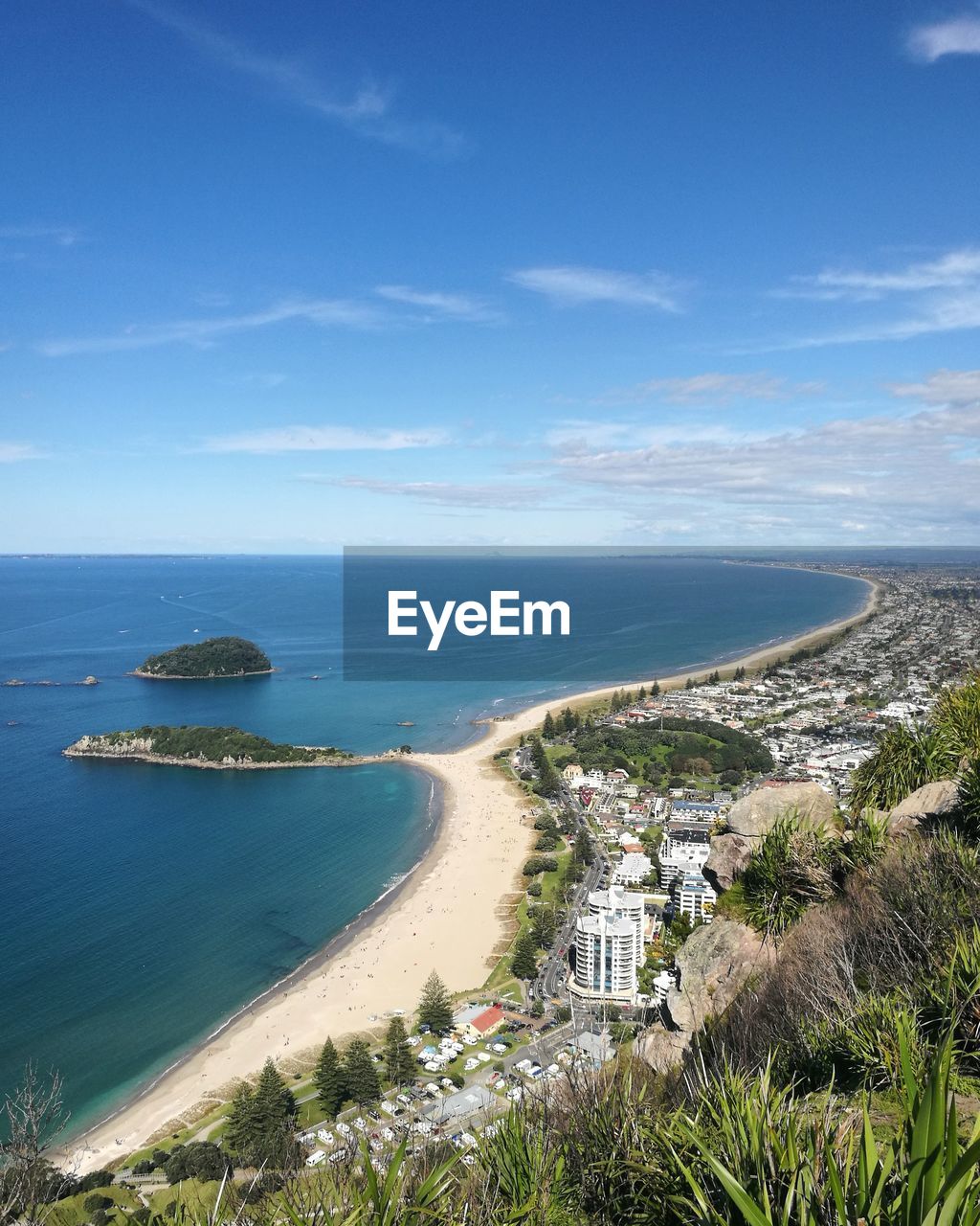 High angle view of calm beach against blue sky