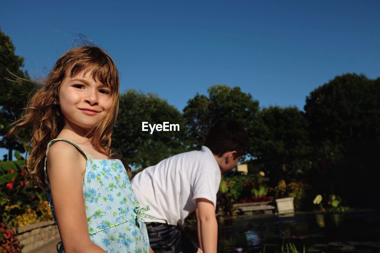 Portrait of girl standing by brother