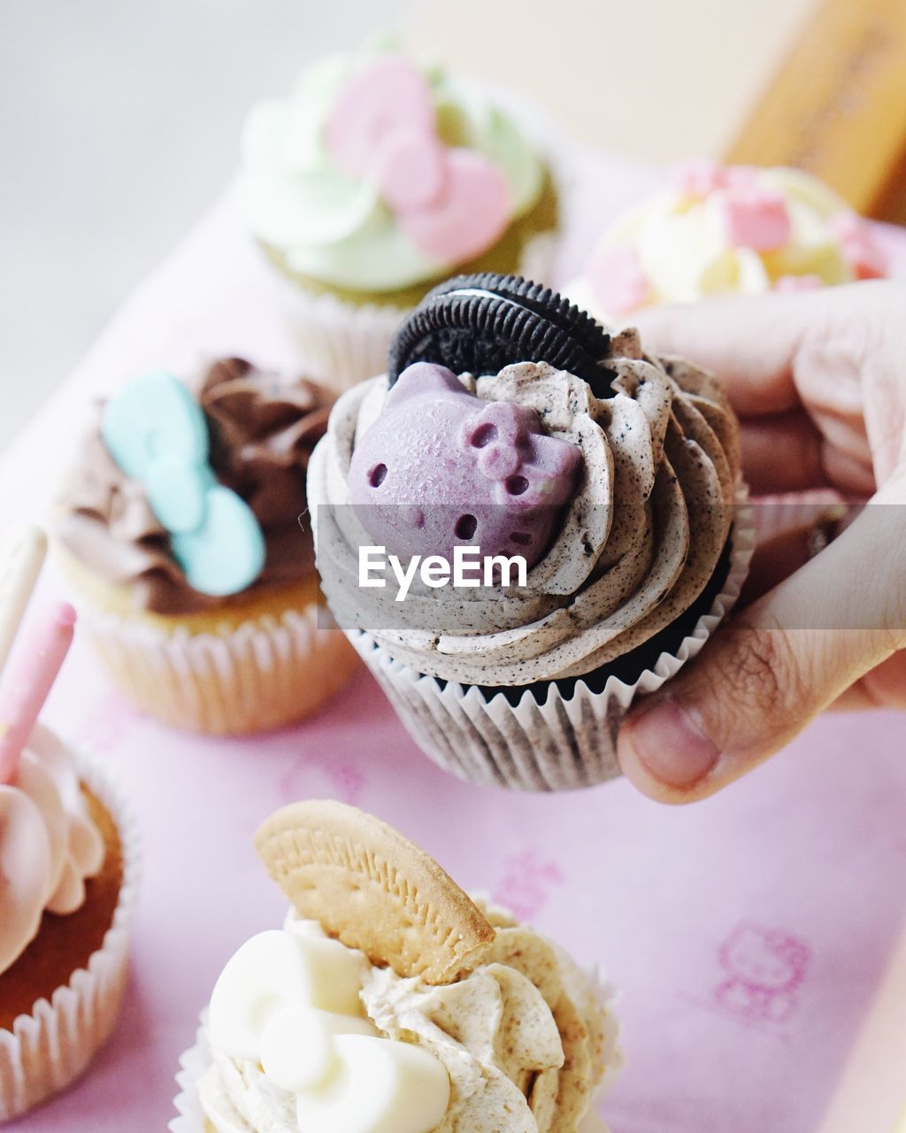 Close-up of cropped hand holding cupcake