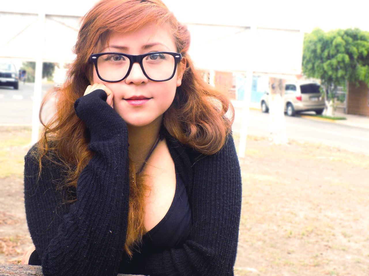 PORTRAIT OF YOUNG WOMAN IN EYEGLASSES