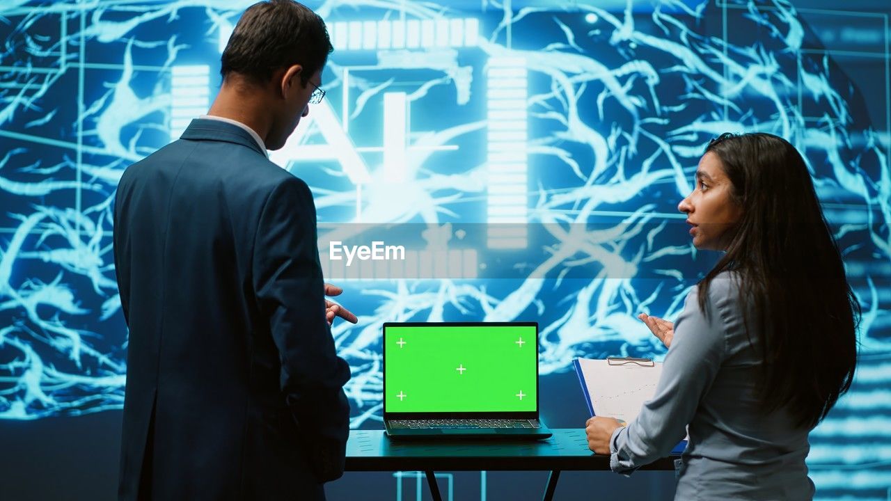 side view of business colleagues working on table