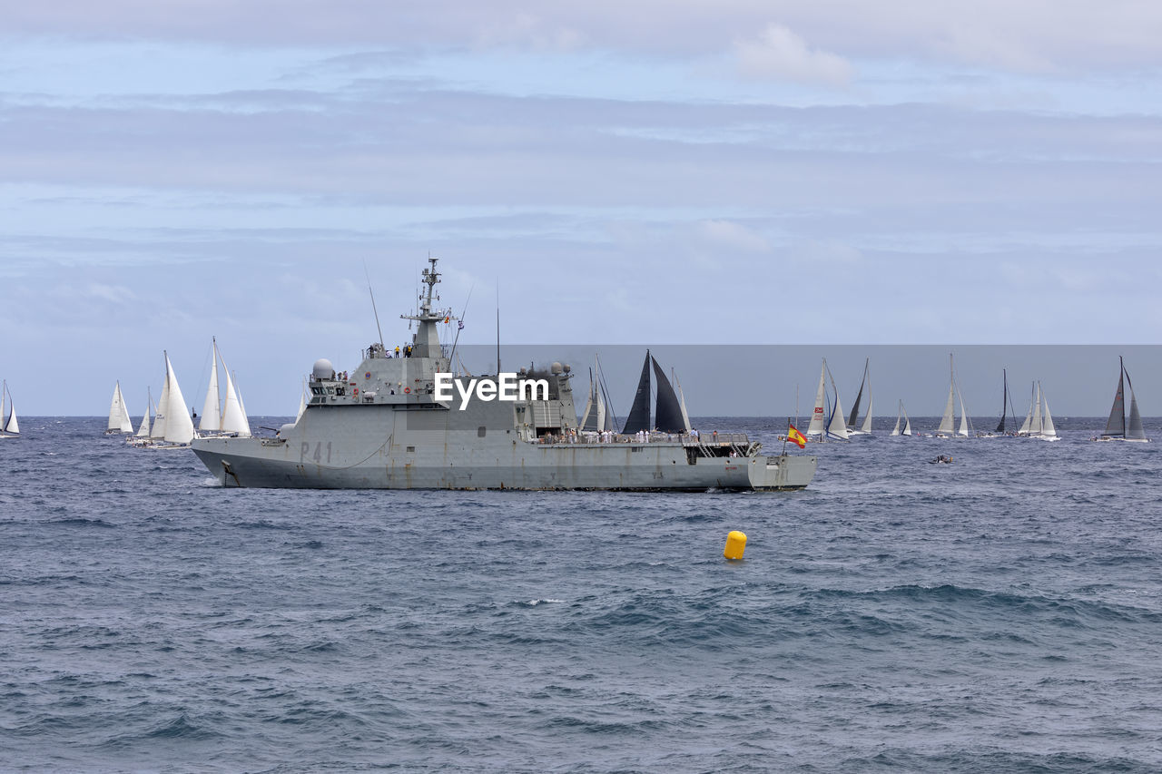 nautical vessel, water, transportation, sea, mode of transportation, sailboat, vehicle, ship, sky, frigate, sailing, nature, boat, cloud, navy, watercraft, travel, guided missile destroyer, destroyer, no people, outdoors, day, warship, naval ship, motion, horizon over water, environment