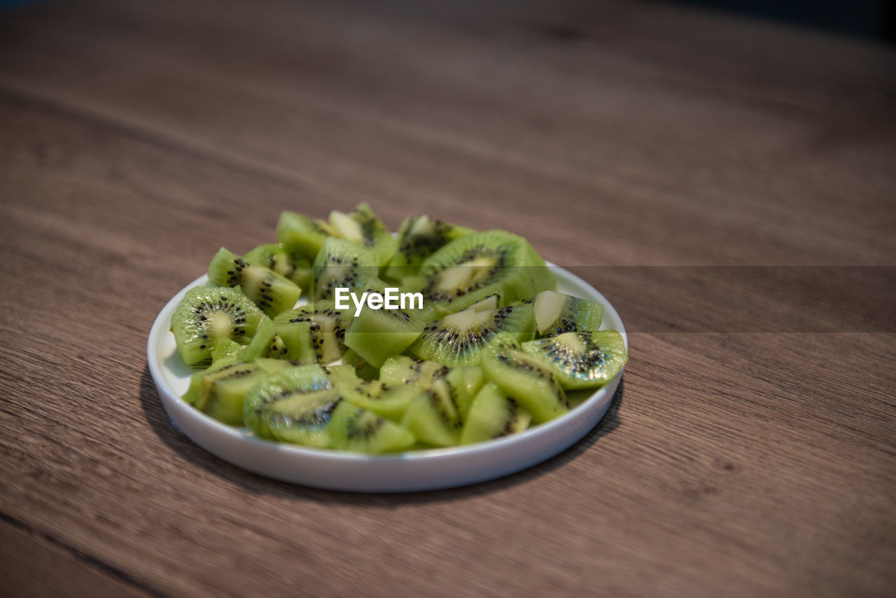 food and drink, food, healthy eating, wellbeing, freshness, wood, dish, cuisine, vegetable, produce, table, indoors, no people, green, close-up, still life, fruit, selective focus, bowl, plant