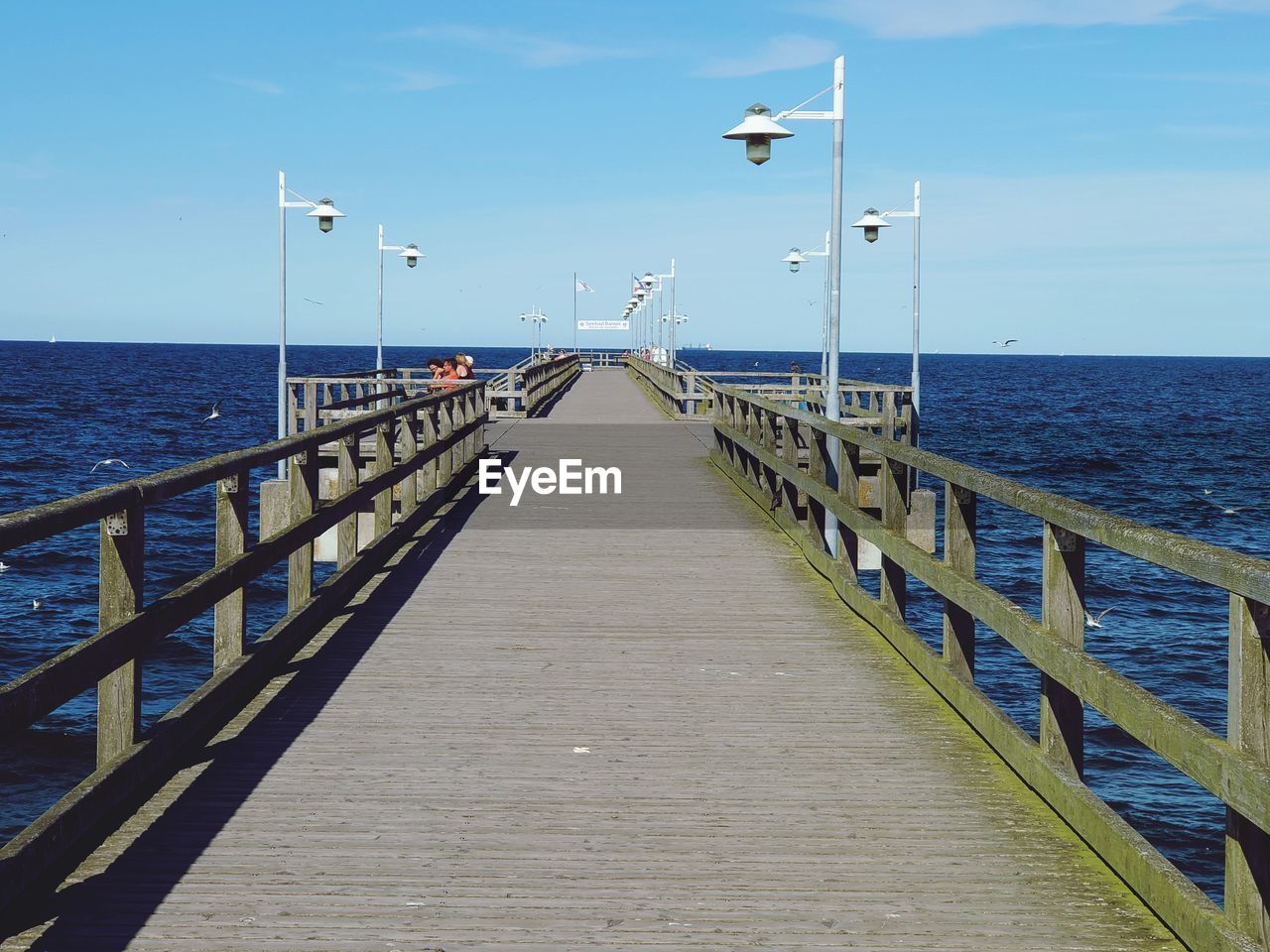 PIER LEADING TO SEA AGAINST SKY