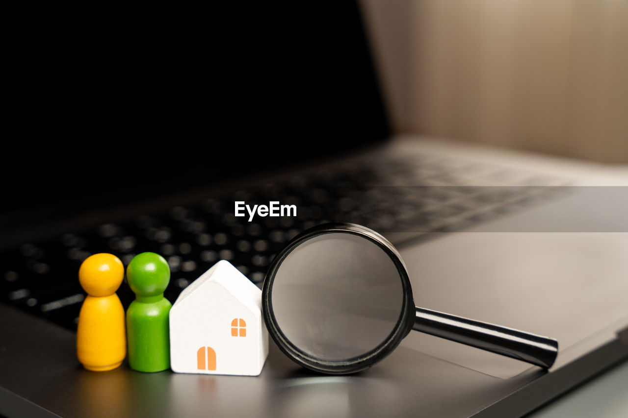 House, family and magnifying glass on laptop keyboard. the concept of searching for housing 