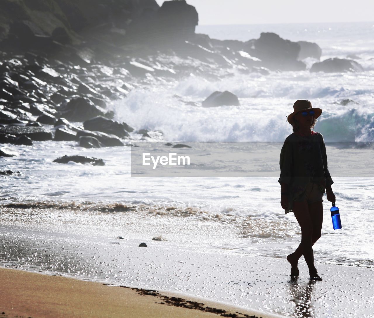 Full length of woman walking on shore at beach