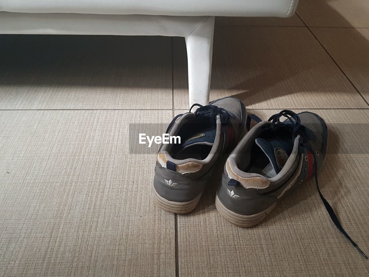 HIGH ANGLE VIEW OF SHOES ON TILED FLOOR