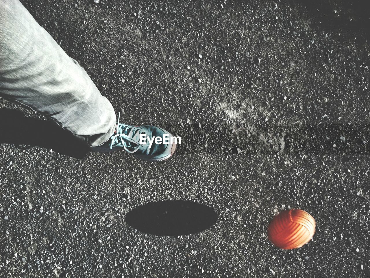 LOW SECTION OF PERSON STANDING ON TILED FLOOR