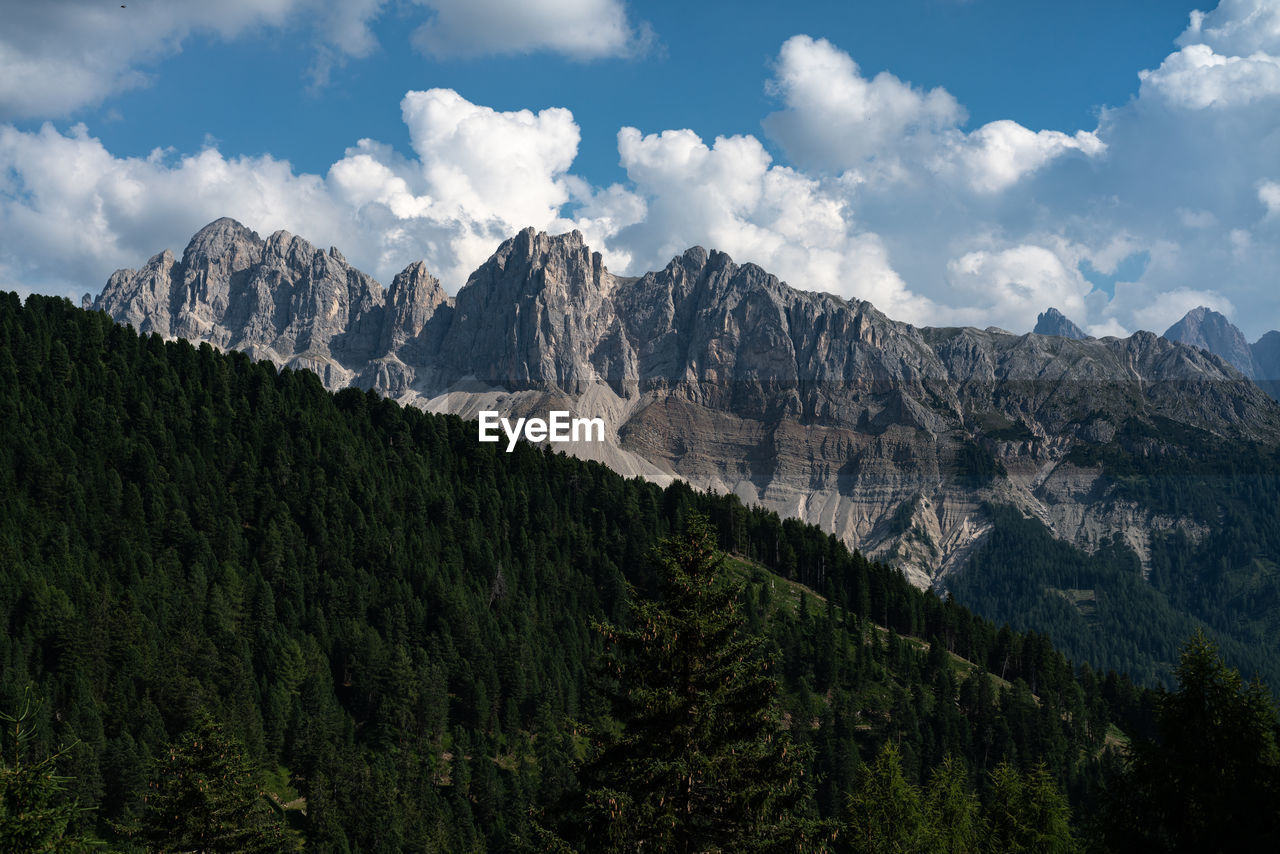 Scenic view of mountains against cloudy sky