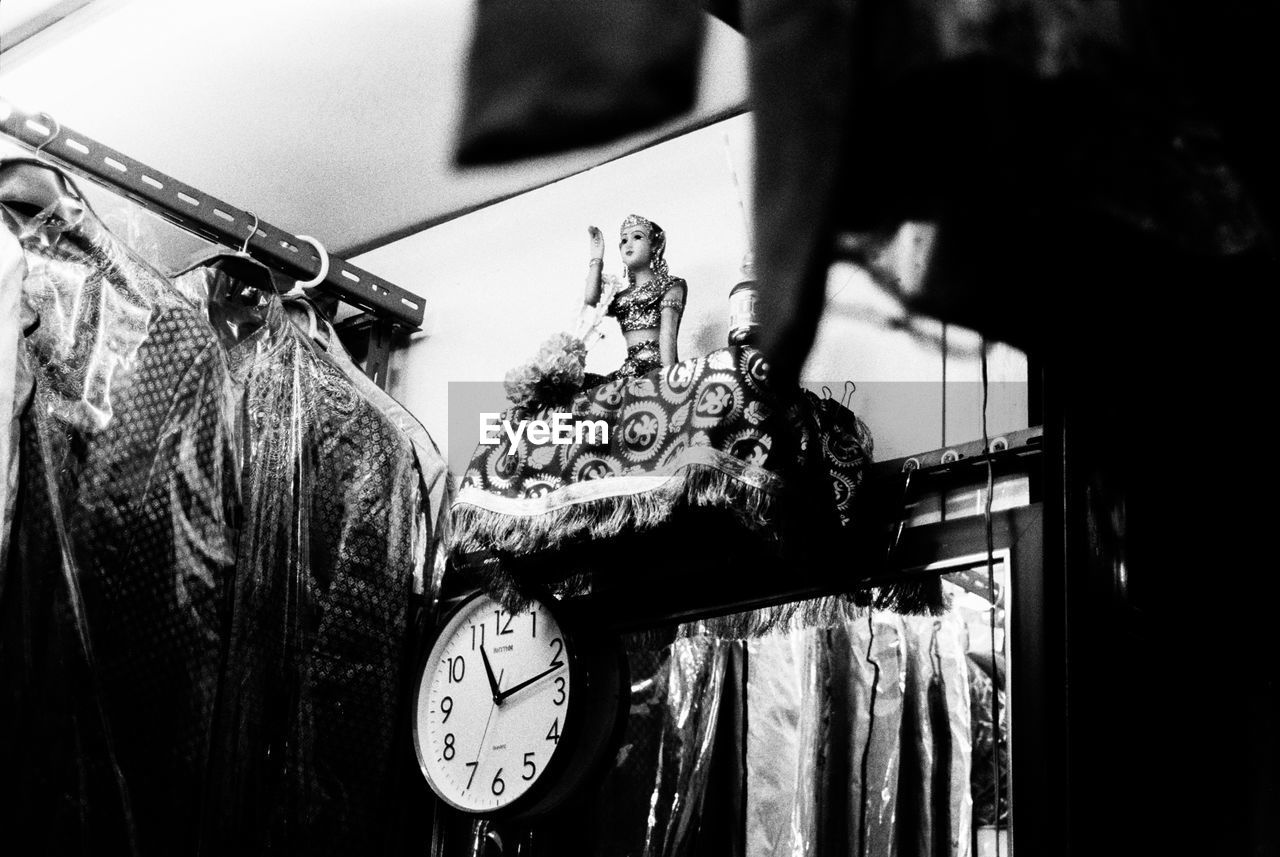 CLOSE-UP OF CLOCK AGAINST BLURRED BACKGROUND