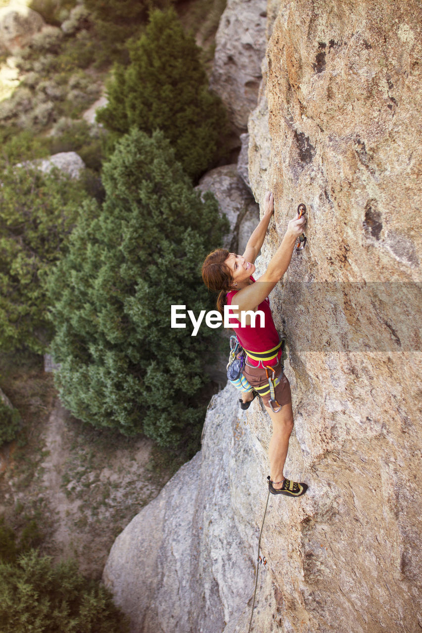 High angle view of female climber climbing mountain