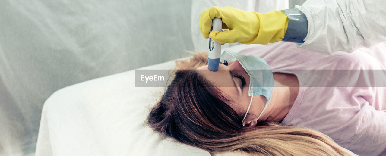 Doctors in a field hospital taking the fever a patient