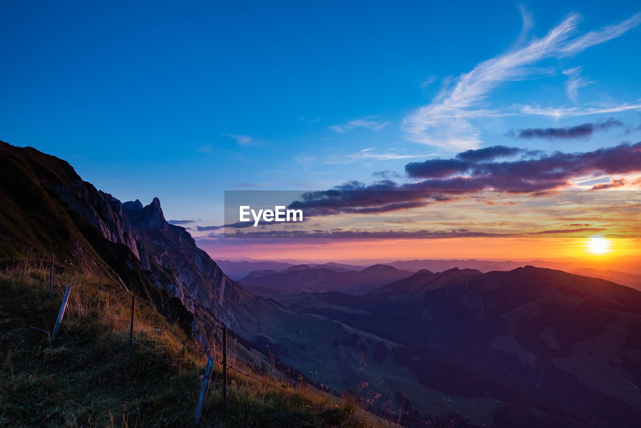 Scenic view of mountains against sky during sunset