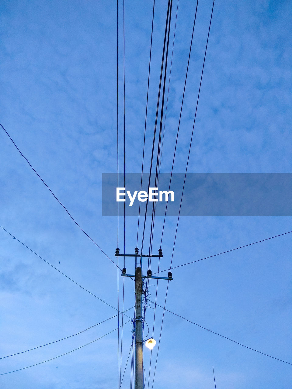LOW ANGLE VIEW OF POWER LINES AGAINST BLUE SKY