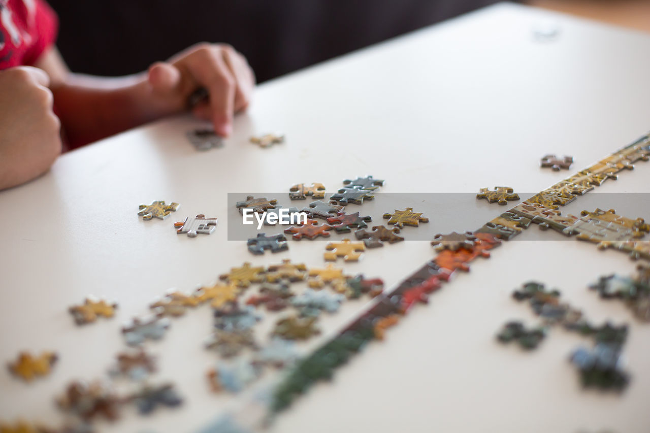 Close up of child putting puzzle together