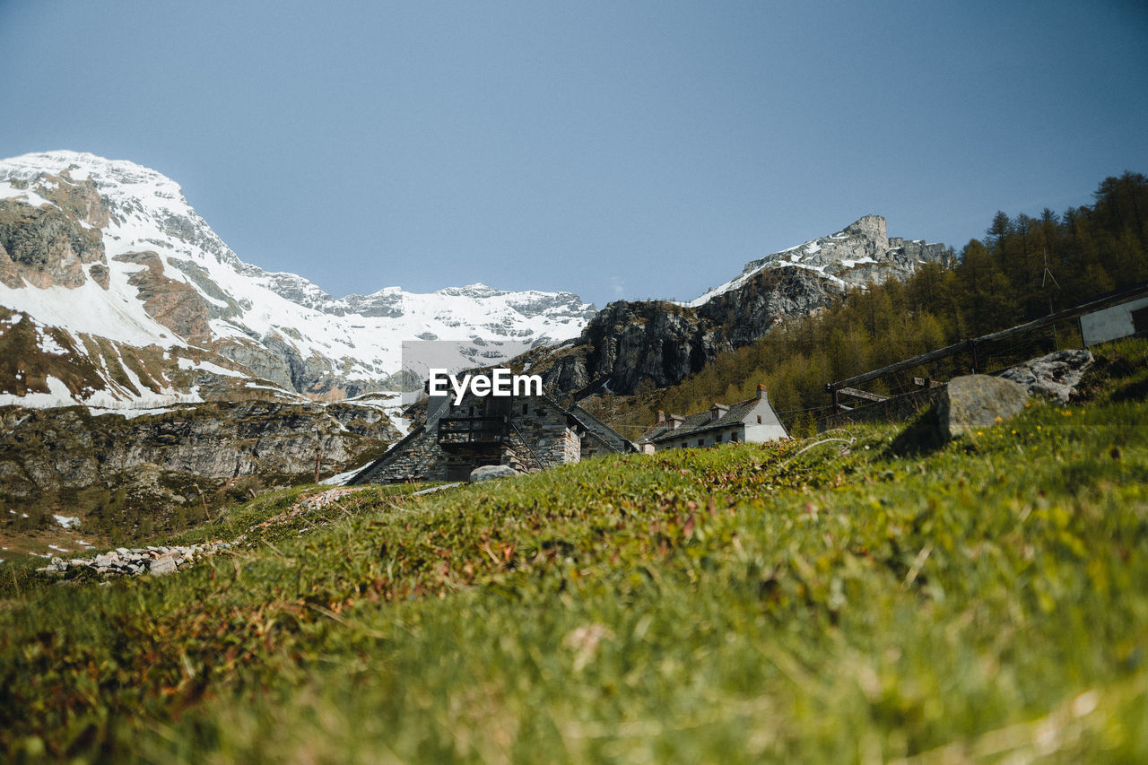 Scenic view of snowcapped mountains against clear sky