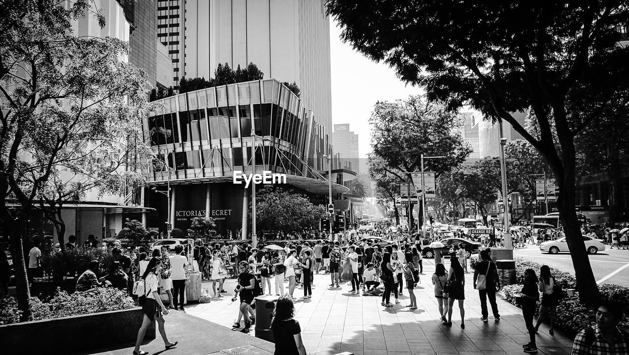 PEOPLE WALKING IN FRONT OF BUILDINGS