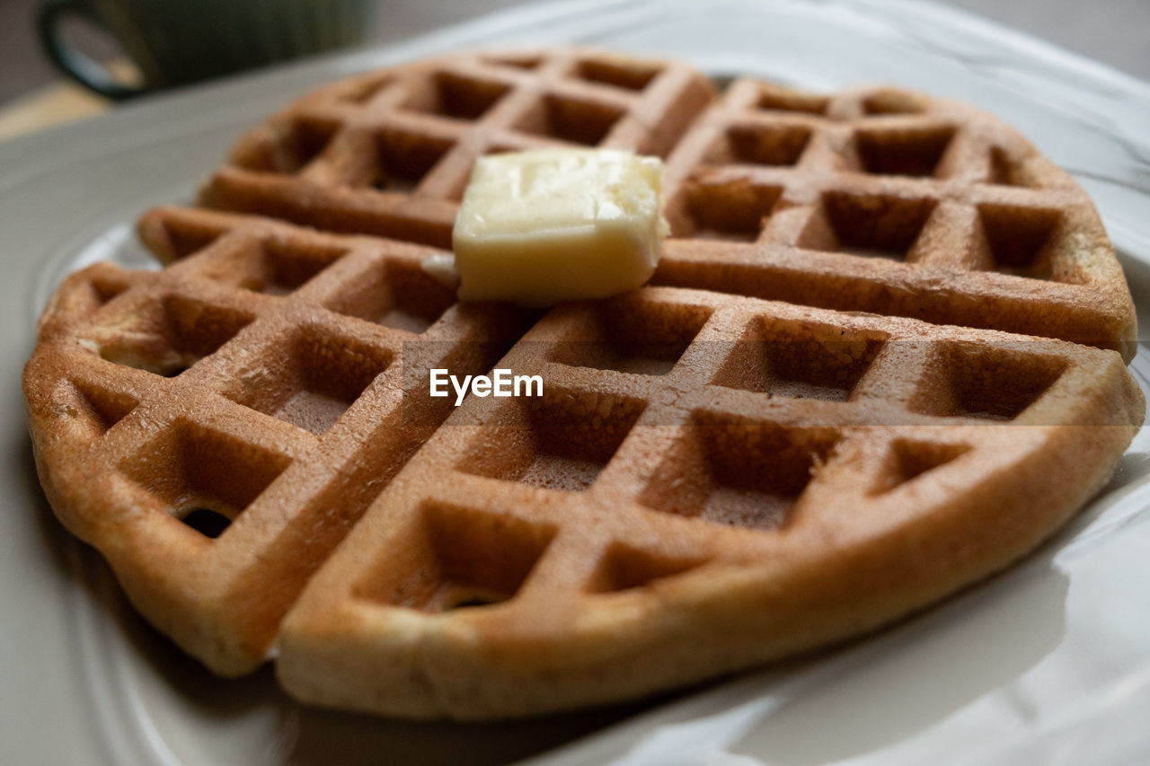 Side view of a waffle with butter