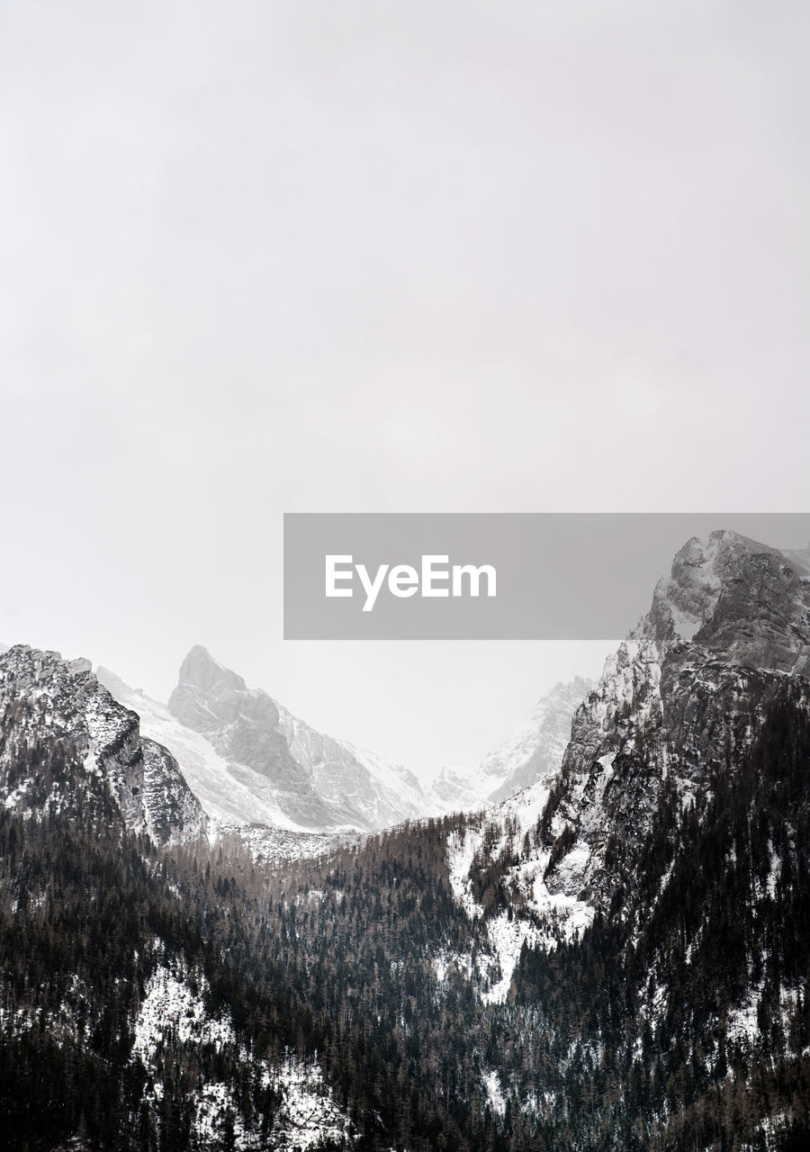 SCENIC VIEW OF MOUNTAINS AGAINST SKY DURING WINTER
