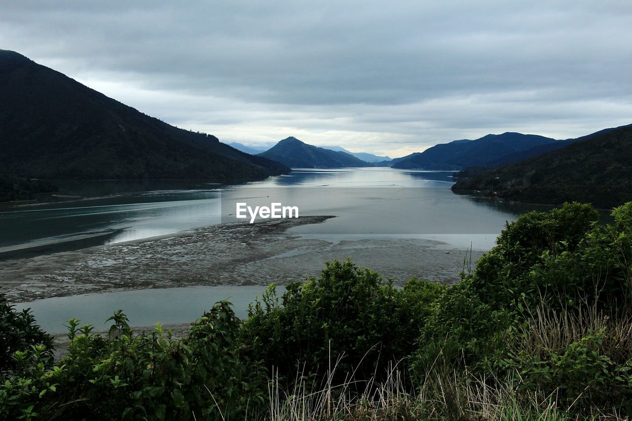 Scenic view of lake and mountains against sky