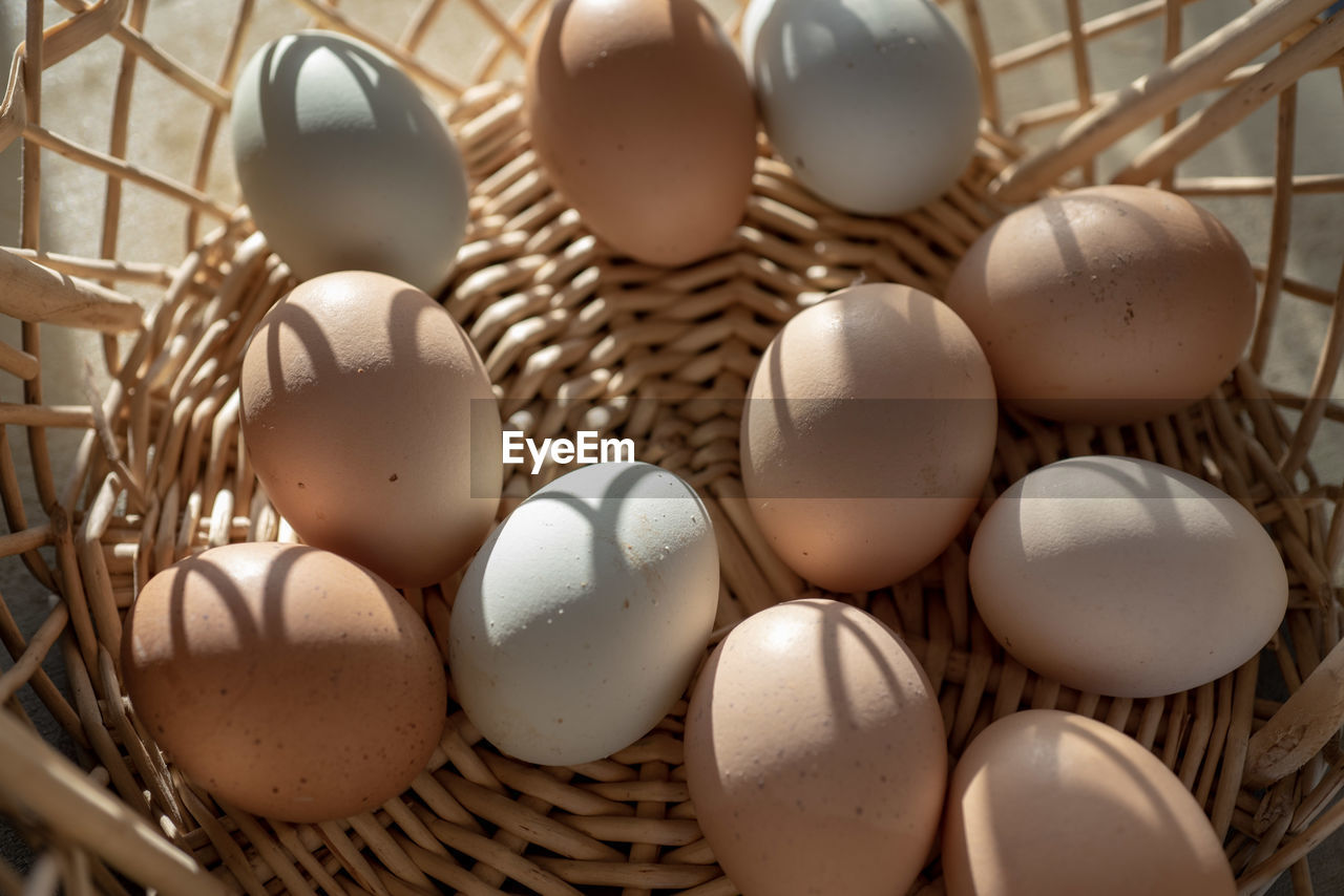 Basket with brown and bluish color eggs from local farmer's market