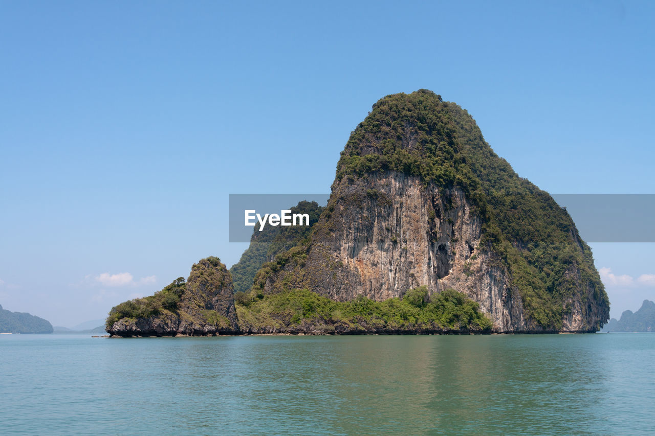 Rock formation in sea against sky