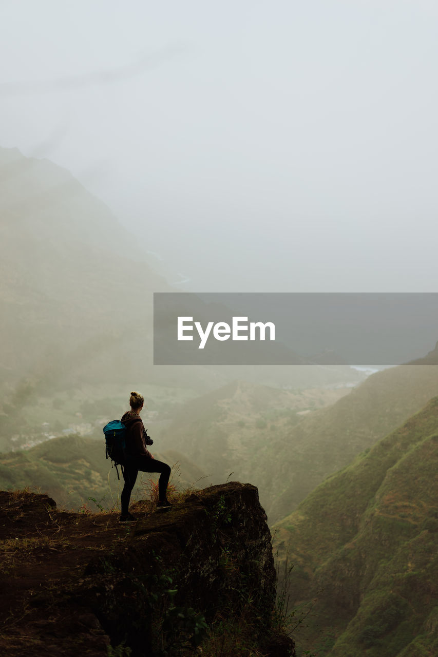 Full length of woman standing on mountain