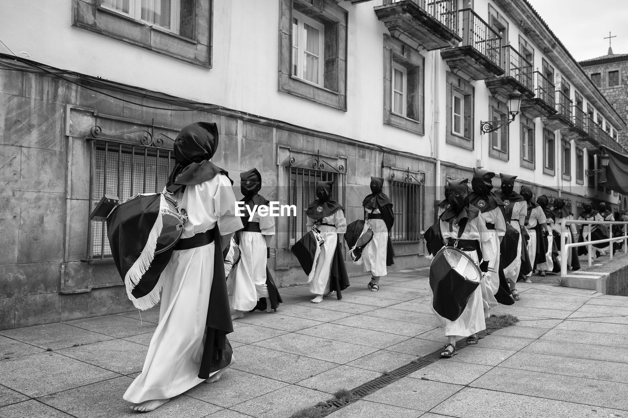 GROUP OF PEOPLE WALKING IN STREET