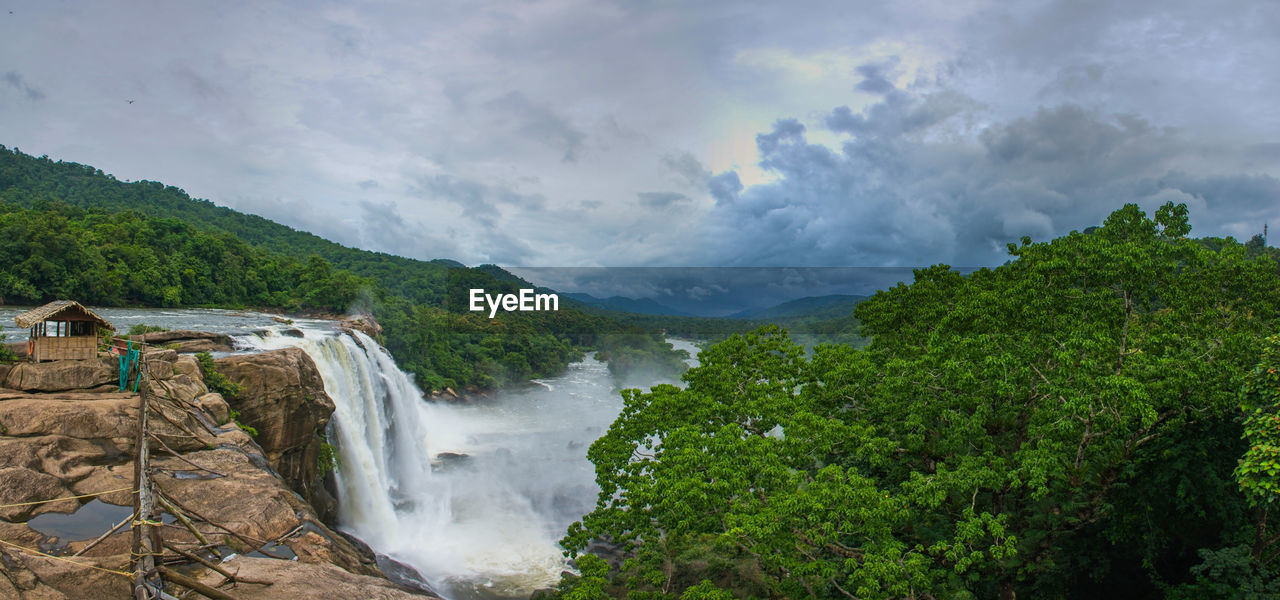 Scenic view of waterfall against sky