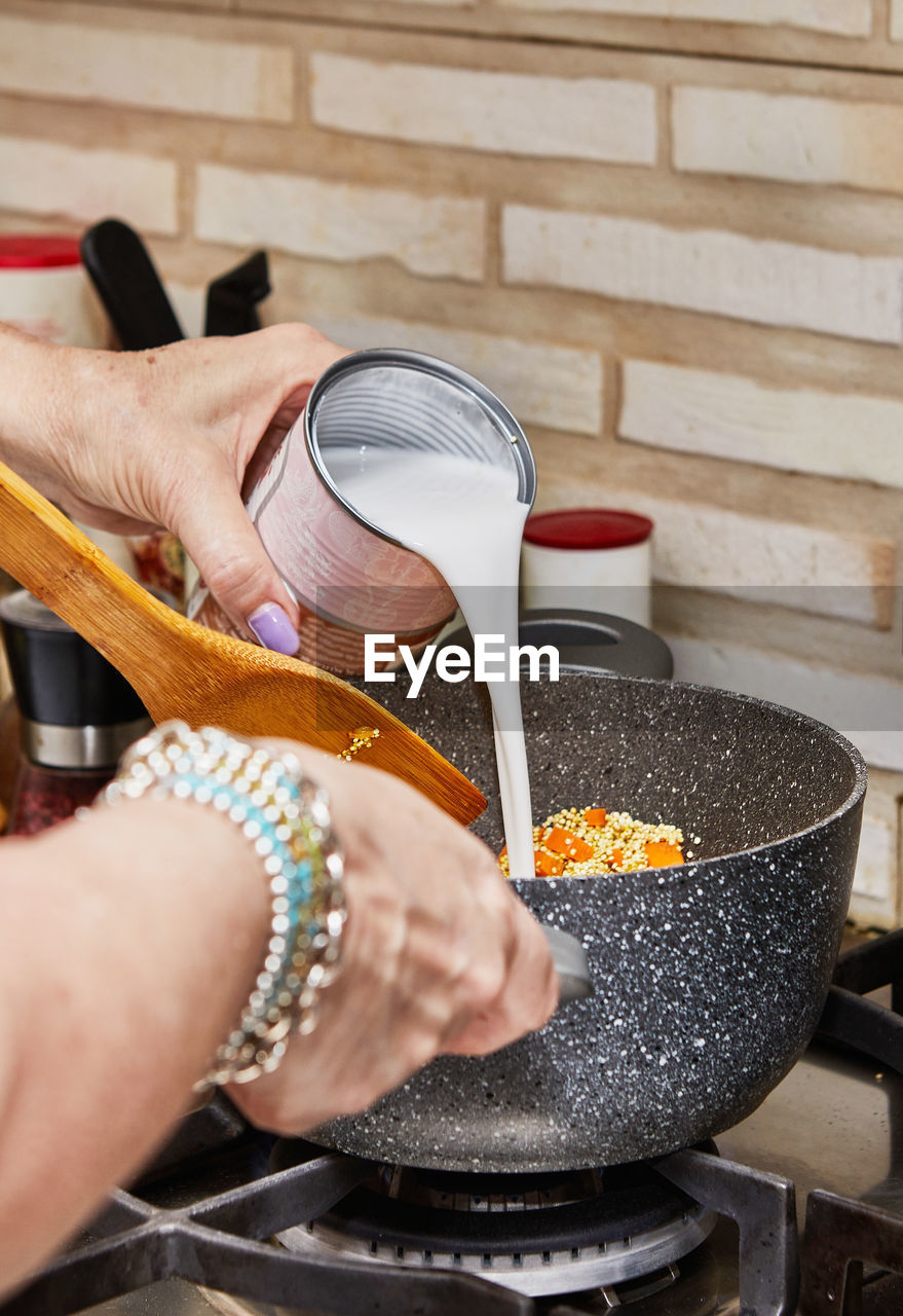 cropped hand of man preparing food on table