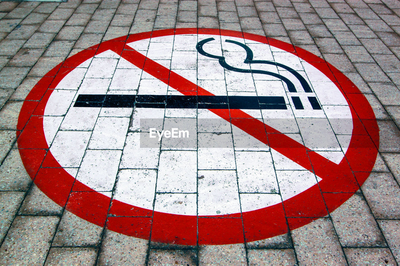 High angle view of no smoking sign on footpath