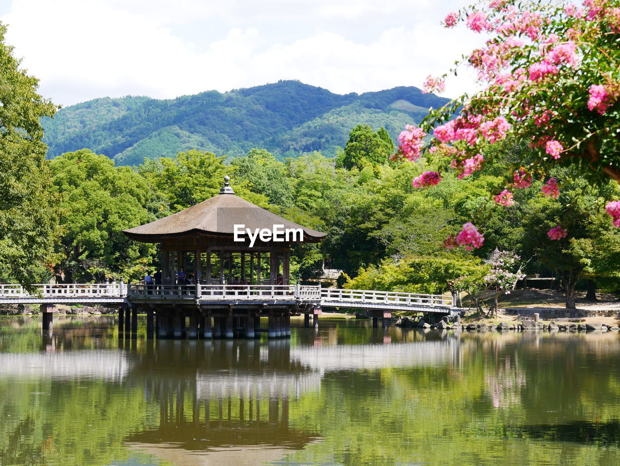 Scenic view of lake by mountain against sky