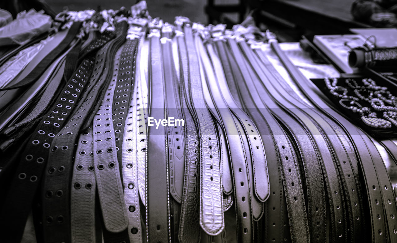 Close-up of belts for sale at market stall