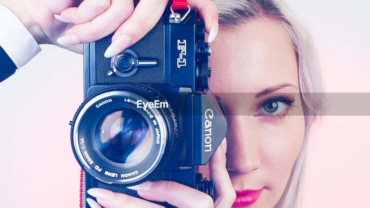 CLOSE-UP PORTRAIT OF WOMAN PHOTOGRAPHING