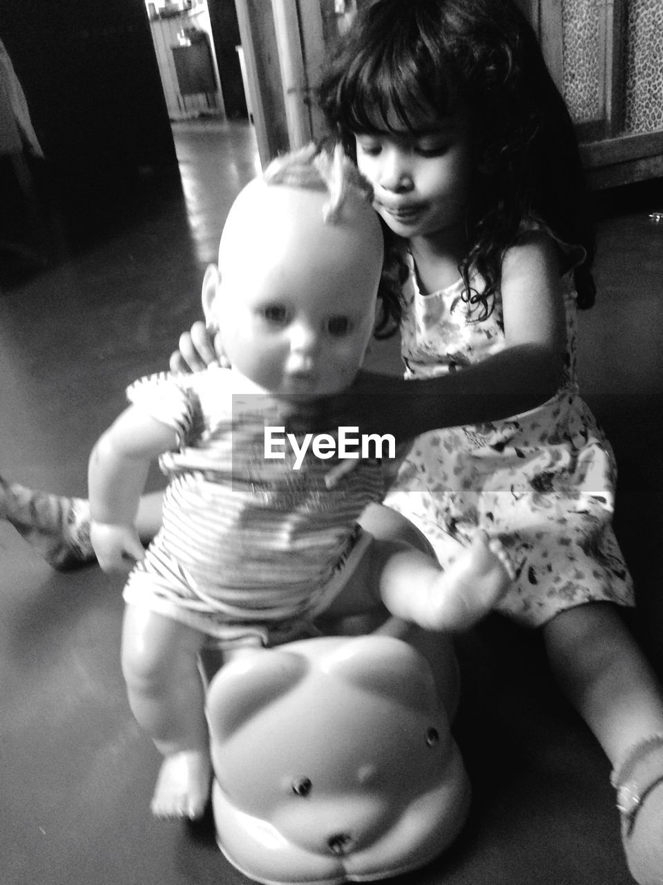 CLOSE-UP OF CUTE GIRL SITTING AND WOMAN LOOKING AT CAMERA