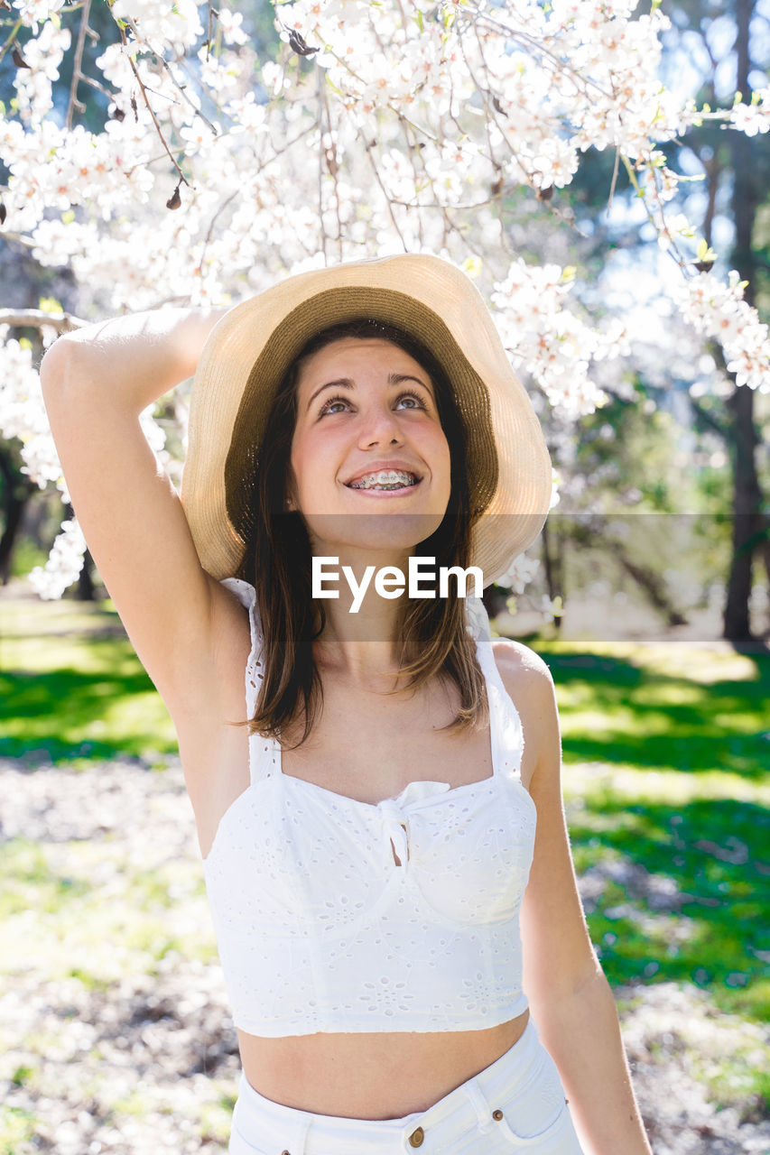 portrait of smiling young woman wearing hat