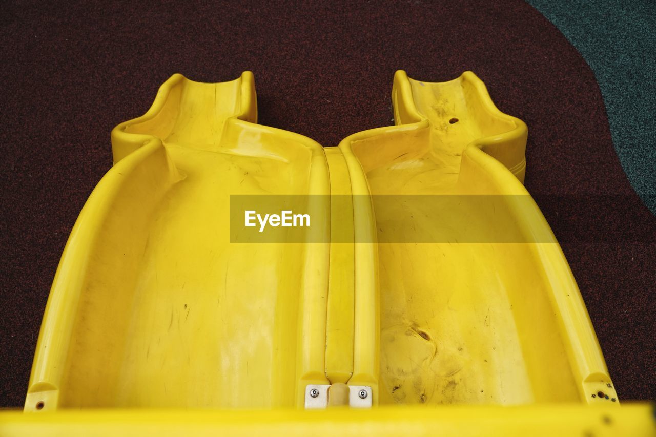High angle view of yellow slide on playground