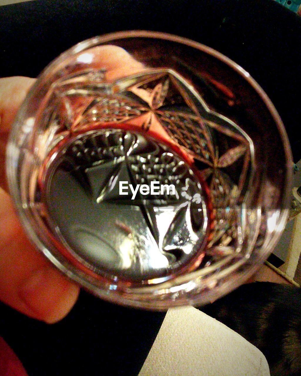 CLOSE-UP OF WOMAN HOLDING GLASS WITH REFLECTION