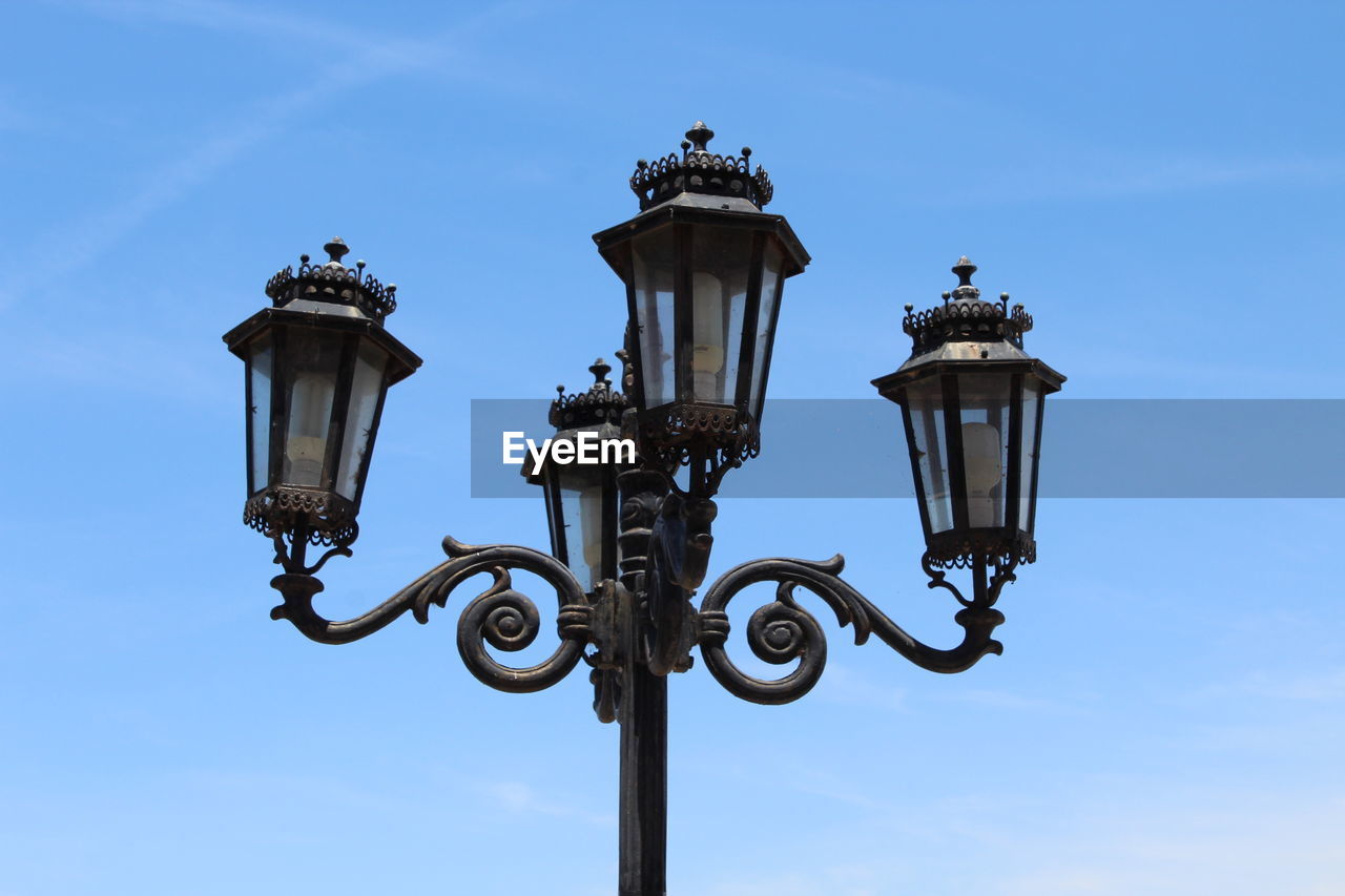 Low angle view of lamp post against sky