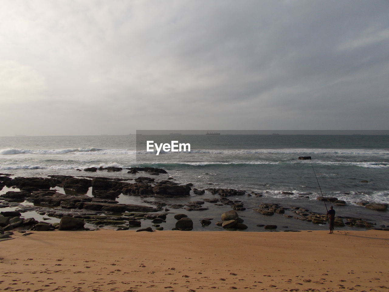 View of calm beach against the sky