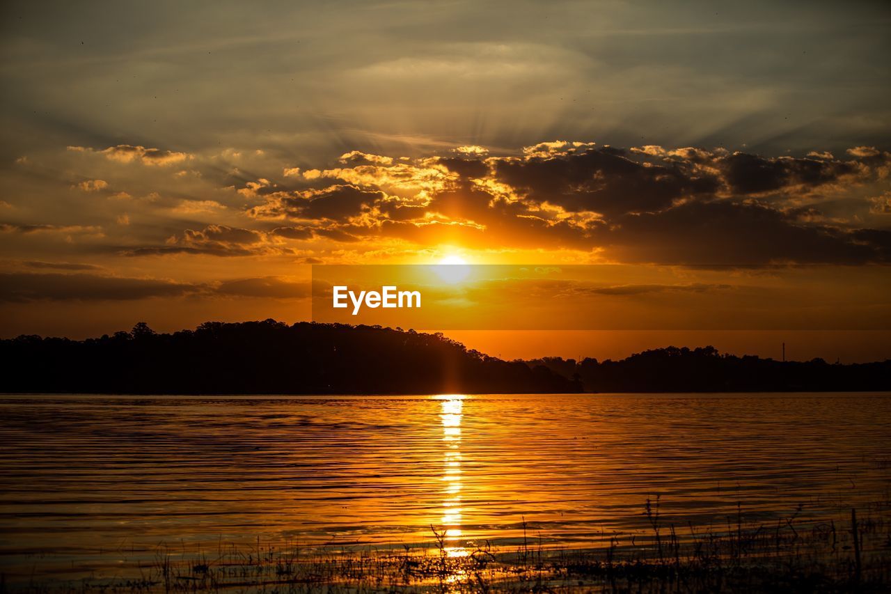 Scenic view of lake against sky during sunset