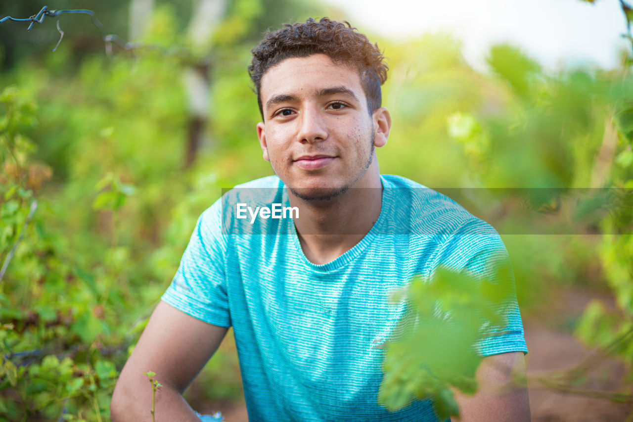 portrait of senior man holding plant