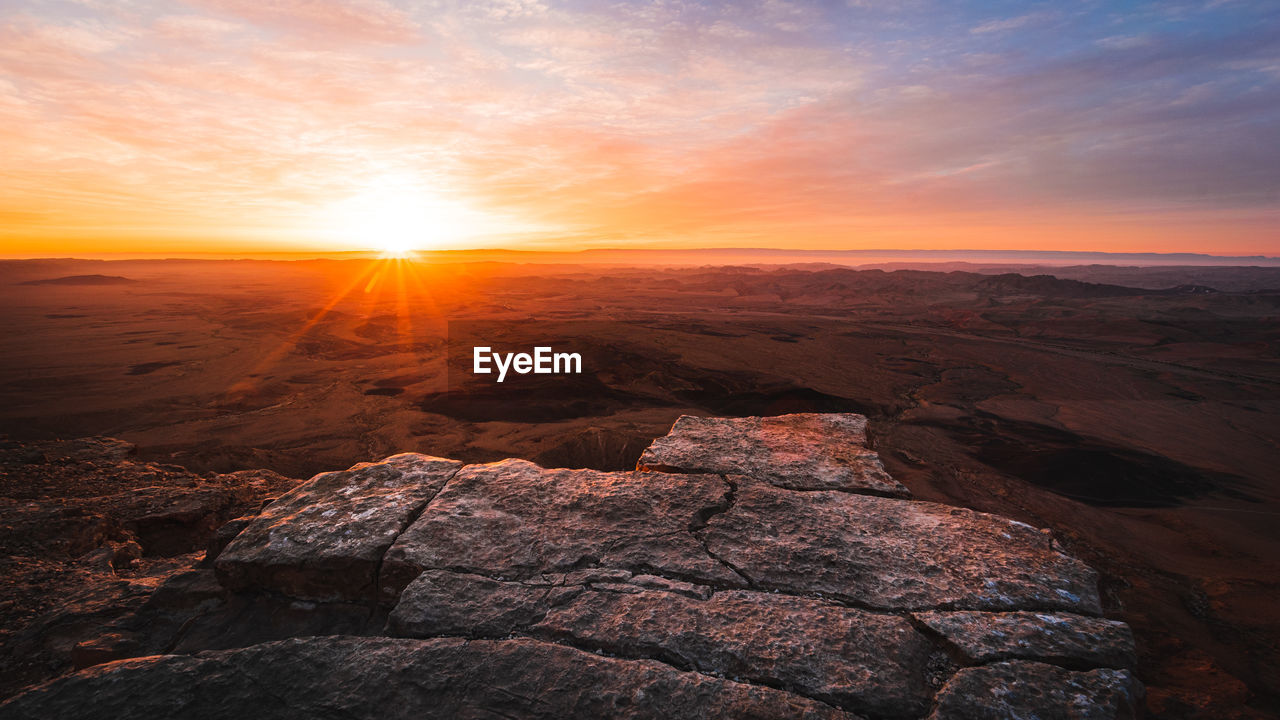 Scenic view of rocks against sky during sunset