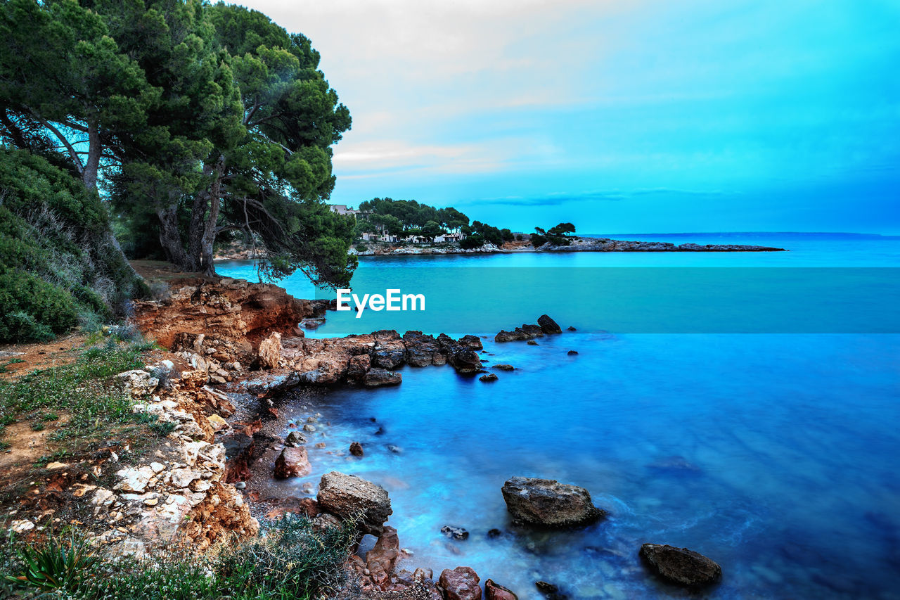 Scenic view of sea against blue sky